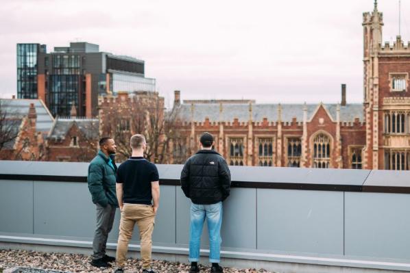 three male students standing on roof terrace of One Elmwood